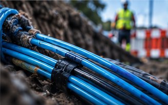 Bundle of blue fibre optic microducts laid in a trench